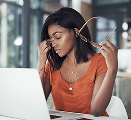 Woman on computer with eye strain.